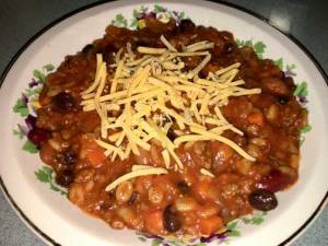 Bowl of chili with shredded cheese